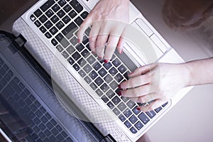 Woman typing on laptop pc