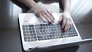 Woman typing on laptop pc