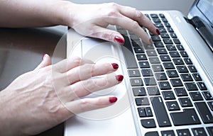 Woman typing on laptop pc