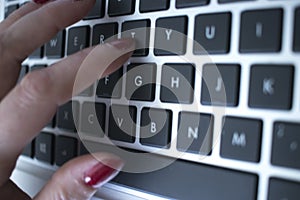 Woman typing on laptop pc