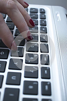 Woman typing on laptop pc