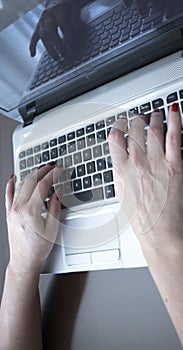 Woman typing on laptop pc