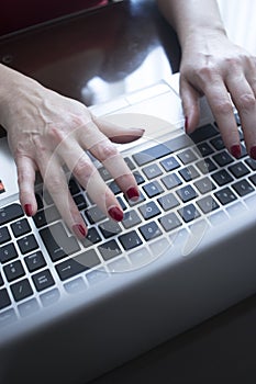 Woman typing on laptop pc