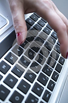 Woman typing on laptop pc