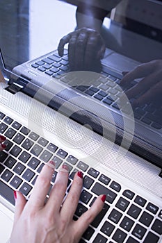 Woman typing on laptop pc