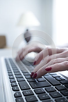 Woman typing on laptop pc