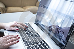 Woman typing on laptop pc