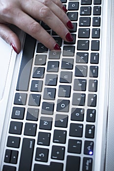 Woman typing on laptop pc