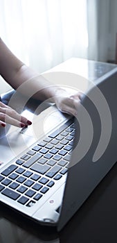 Woman typing on laptop pc