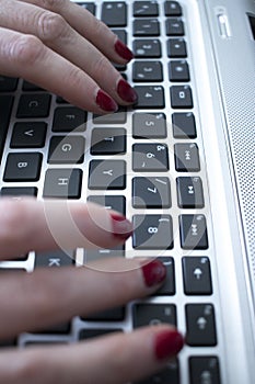 Woman typing on laptop pc