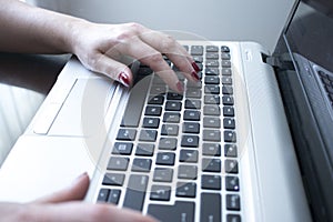 Woman typing on laptop pc