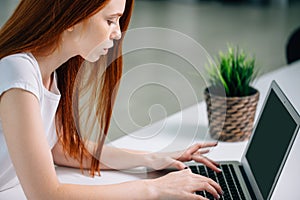 Woman typing on laptop at workplace Woman working in home office hand keyboard