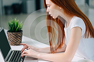 Woman typing on laptop at workplace Woman working in home office hand keyboard