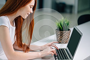 Woman typing on laptop at workplace Woman working in home office hand keyboard