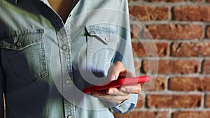 Woman typing message using her smartphone