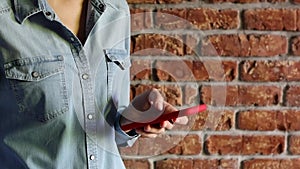 Woman typing message using her smartphone