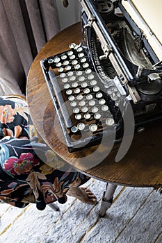 Woman typing on an old typewriter.