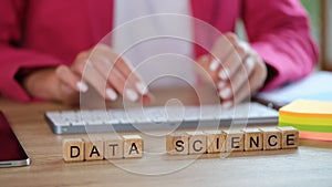 Woman is typing scientific data graphs and statistics on keyboard