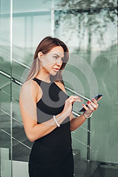 woman typing on smartphone