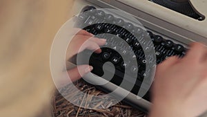 Woman typing on a typewriter close up