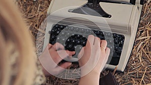 Woman typing on a typewriter close up