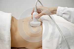 Woman during an ultrasound examination of abdominal cavity