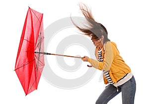 Woman with umbrella caught in gust of wind on white background