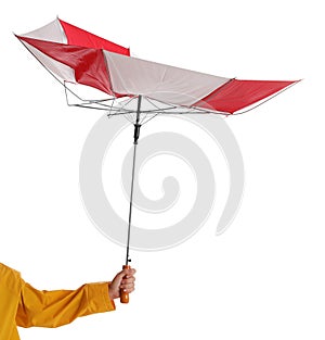 Woman with umbrella caught in gust of wind on white background, closeup