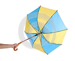 Woman with umbrella caught in gust of wind on white background, closeup