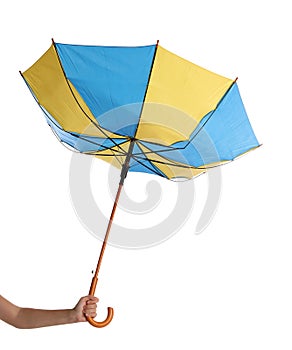 Woman with umbrella caught in gust of wind on white background, closeup