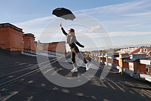 Woman with umbrella is happy on the roof of Saint Petersburg, Russia. Cityscape