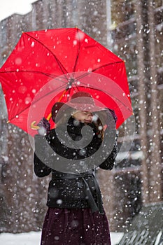 Woman with umbrella and snowfall freez