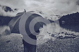 Woman with umbrella standing in the rain