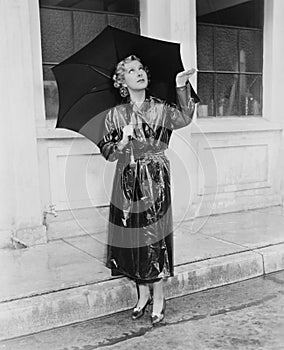 Woman with umbrella testing for rain