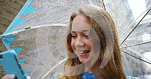 Woman, umbrella and texting in rain, street and happy with web blog update on holiday in Barcelona. Girl, person and