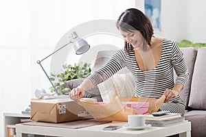 Woman unboxing a parcel photo