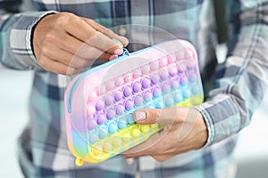 Woman is unbuttoning bright pops it pencil case