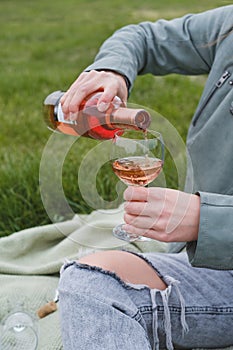 Woman uncork the bottle outdoors