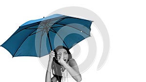 Woman under blue umbrella cowering with fear