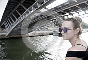 Woman under bridge in Paris, France