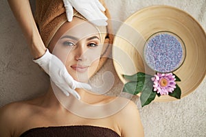 Woman under professional facial massage in beauty spa