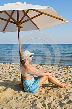 Woman under a solar umbrella