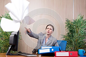 The woman under stress tossing papers in the office