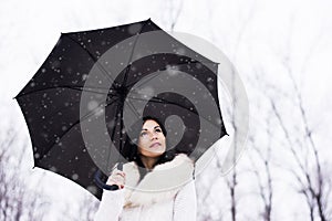Woman under umrella while snowing