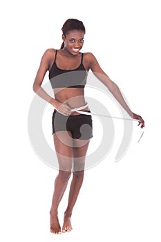 Woman In Undergarments Measuring Waist With Tape