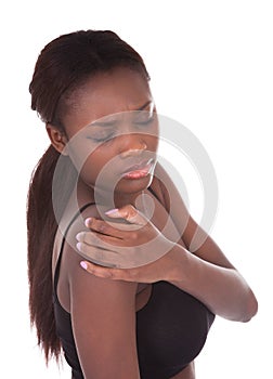 Woman in undergarments suffering from shoulderache