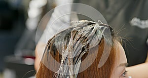 Woman undergo hair treatment at beauty salon photo