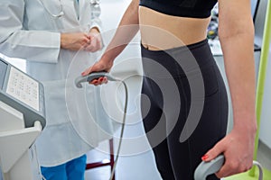 A woman undergoes a body composition analysis with a professional health expert