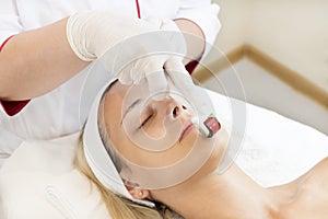 The woman undergoes the procedure of medical micro needle therapy