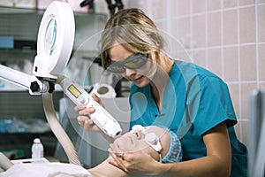 Woman undergoing laser skin treatment